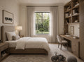 A beautifully styled bedroom featuring a light wood bed frame with white bedding, beige curtains, a built-in wooden desk and shelving unit, and a large window looking out onto a green garden.