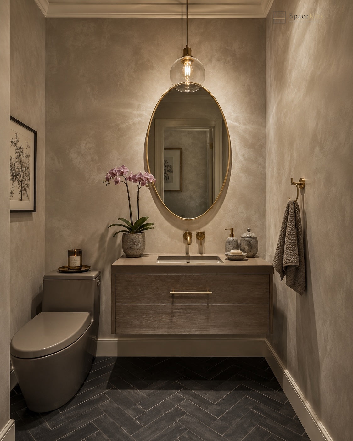 A modern bathroom vanity area with a wall-mounted wood sink cabinet, oval mirror, pendant light, dark herringbone tile floor, toilet, and a towel on the wall.